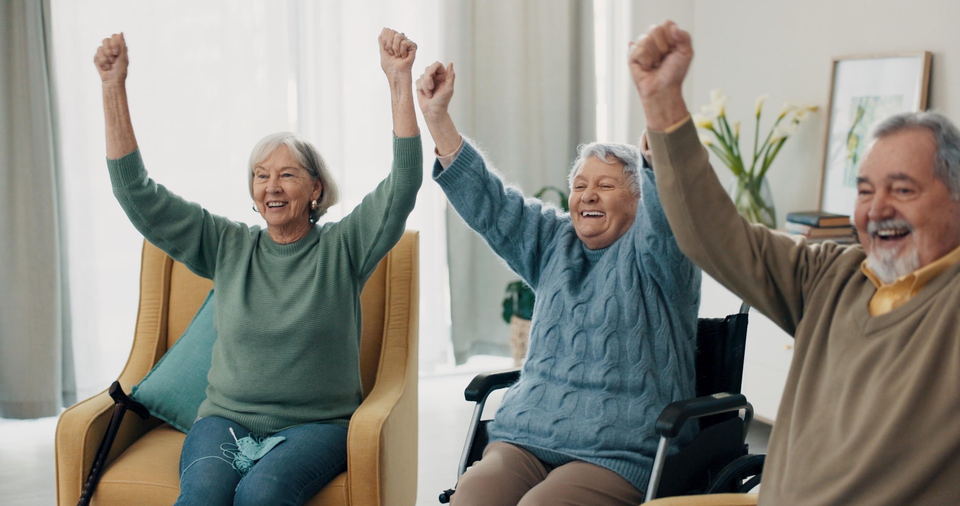 Senior people, friends and applause watching tv at home, living room and house during retirement together. Wheelchair, person with disability and elderly group in celebration, support and success